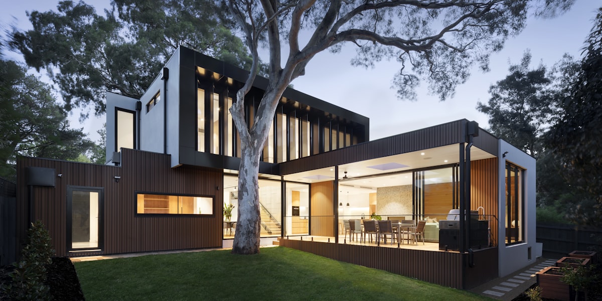 Modern Australian home with palm trees and green lawn